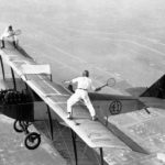 25 Oct 1925, Los Angeles, California, USA --- Original caption: Gladys Roy, who gets her fun out of doing unusual things with airplanes, also likes to play tennis. Ivan Unger (member of the "Flying Black Hats") is her opponent. Frank Tomac is the pilot who keeps the plane at 3,000 feet. The only problem with this match is trying to retrieve a ball after it has bounced off the wing of the plane and plunged a few thousand feet. --- Image by © Bettmann/CORBIS